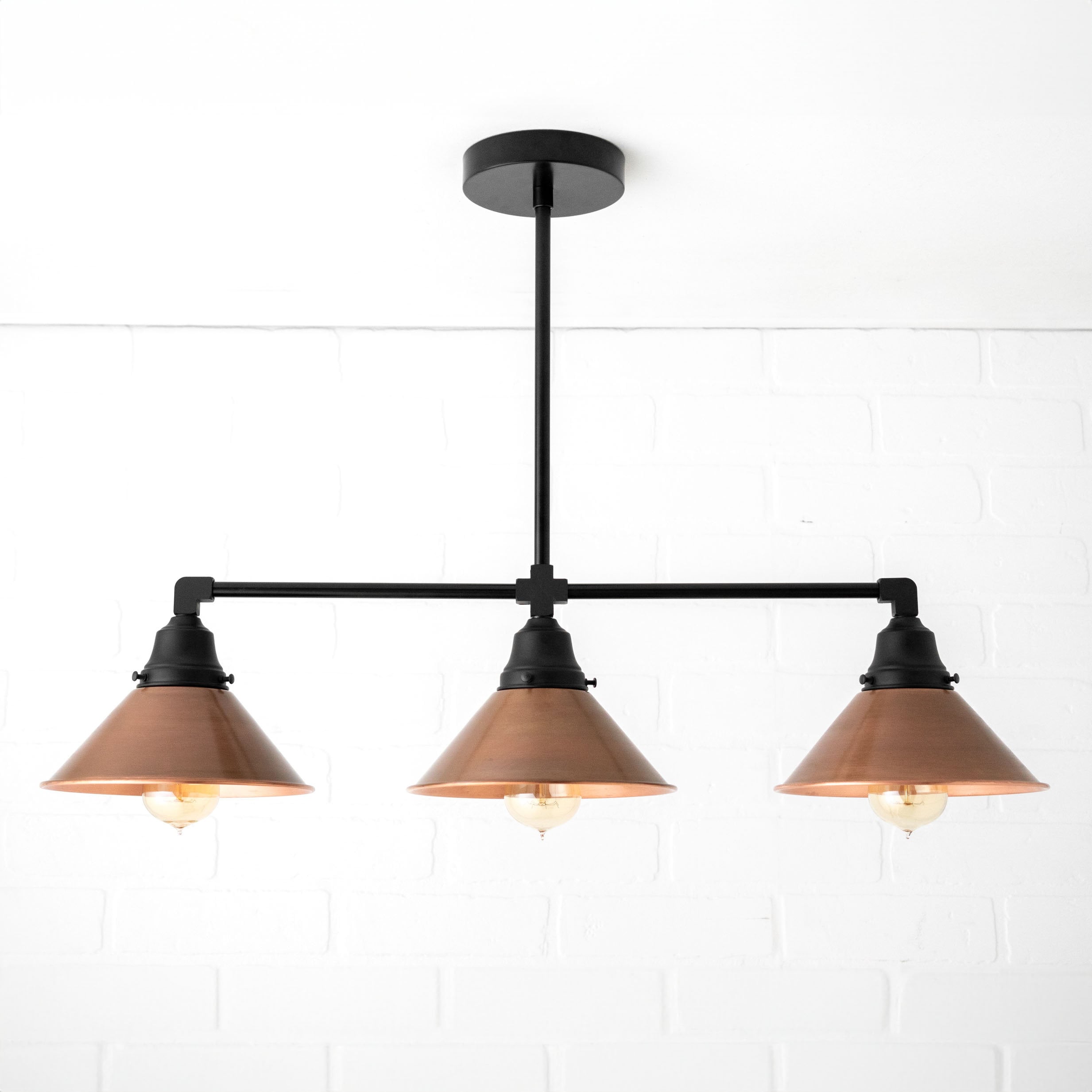 Conique Metal Aged Copper Three-Light Pendant – Sleek Industrial Fixture for Dining Rooms