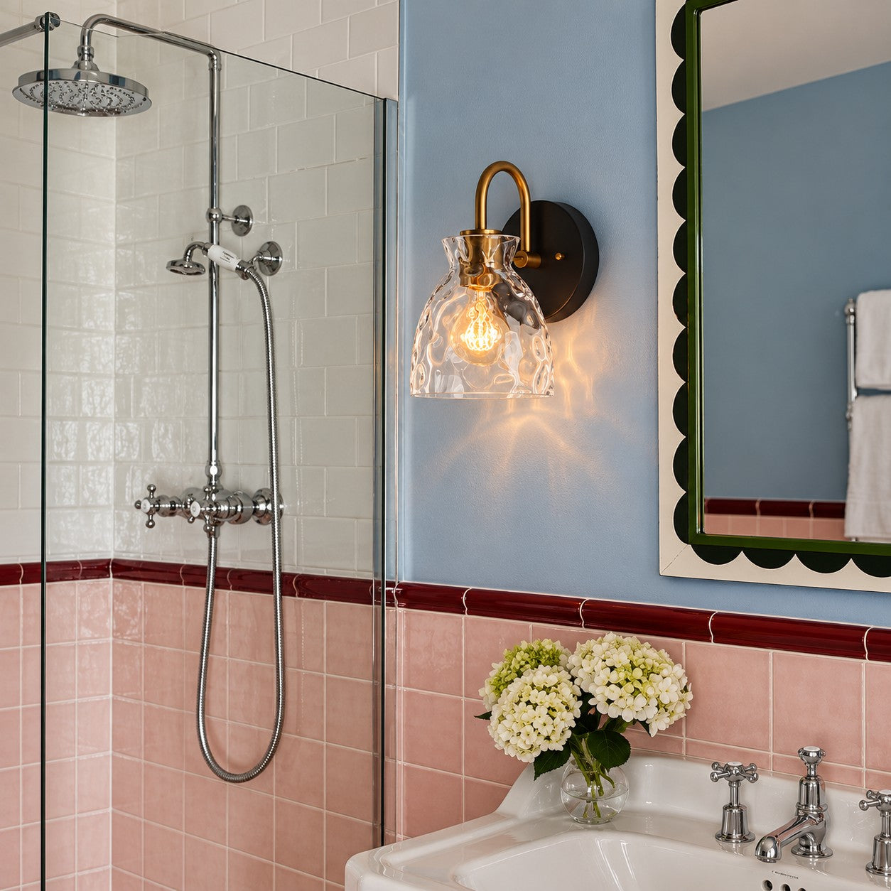 Gildon two-head ripple glass vanity sconce above a bathroom mirror
