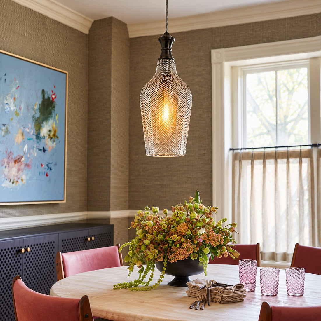Gildon tall smoke glass pendant styled over a round dining table