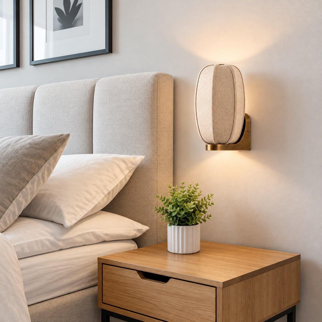 Loomis oval wall sconce above a wood nightstand