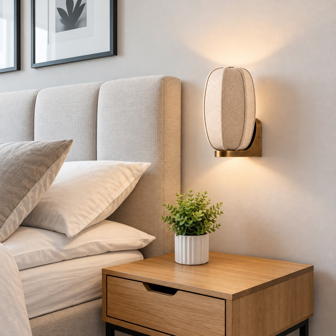Loomis oval wall sconce above a wood nightstand