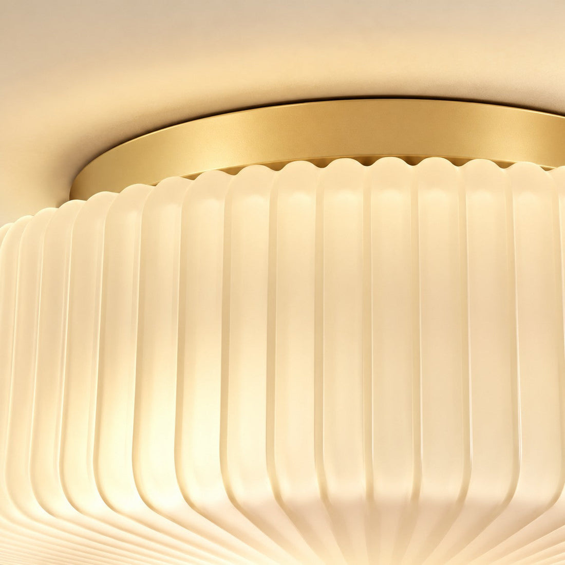 Close-up of the ribbed opaline shade beneath the brass canopy