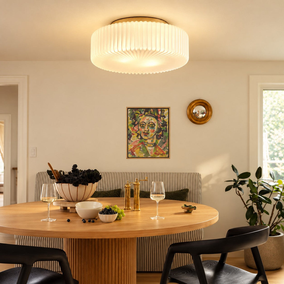Ceiling lamp styled over a dining table with blue chairs