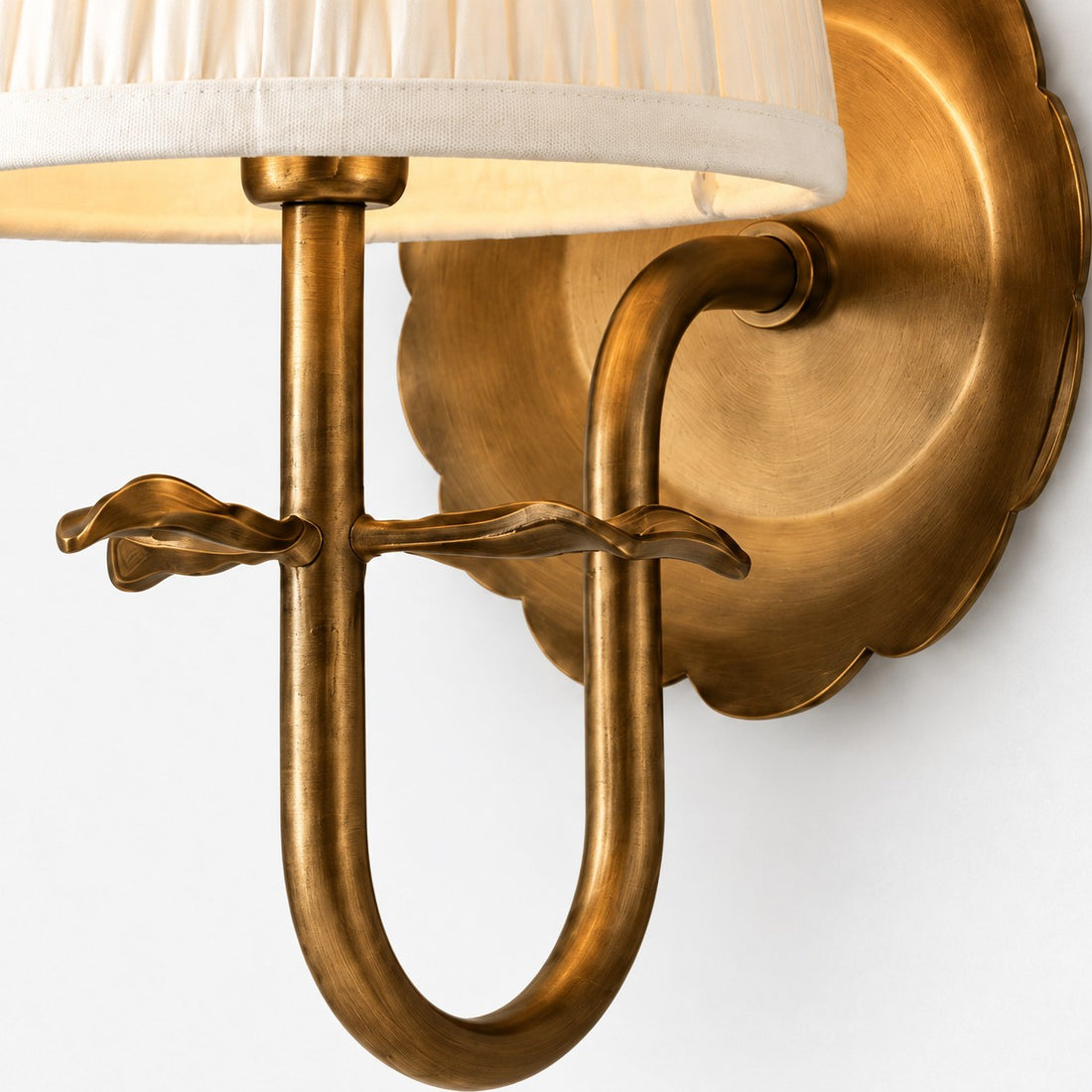 Luvora brass arm, leaf motif, and scalloped backplate