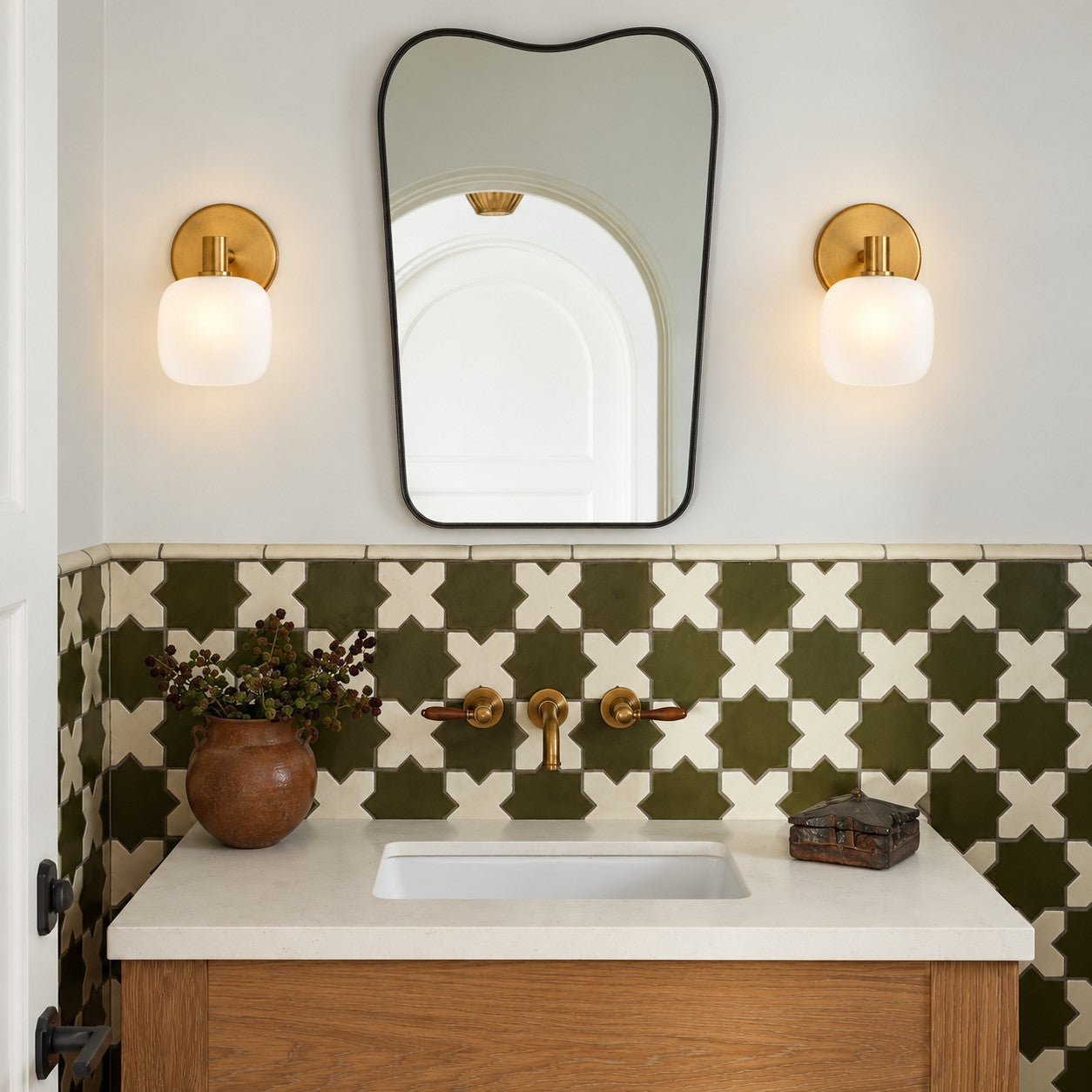 Opelina frosted glass wall sconce styled on a white tile bathroom vanity