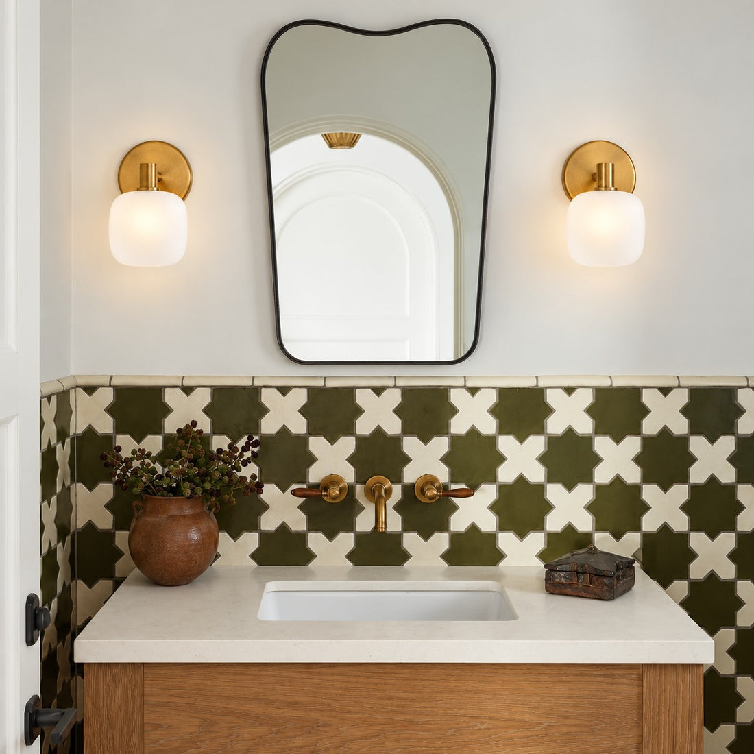 Opelina frosted glass wall sconce styled on a white tile bathroom vanity