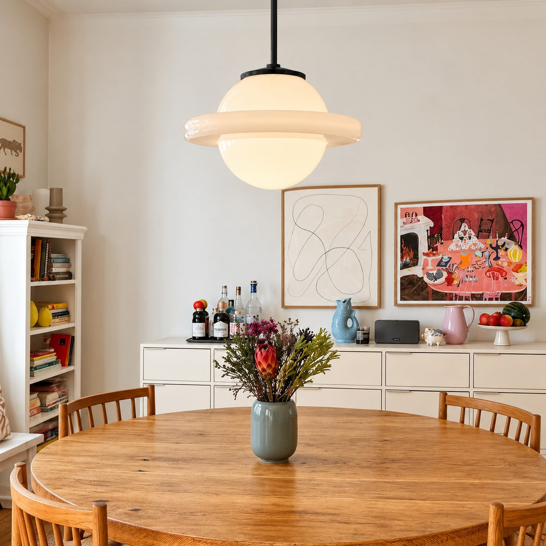 Opelina Model F milk glass pendant over a round dining table