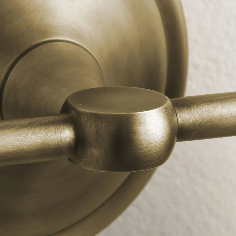 Opelina milk glass wall sconce brass arm joint close-up