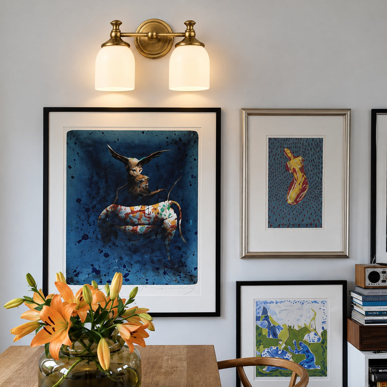 Opelina brass two-head milk glass wall sconce above artwork