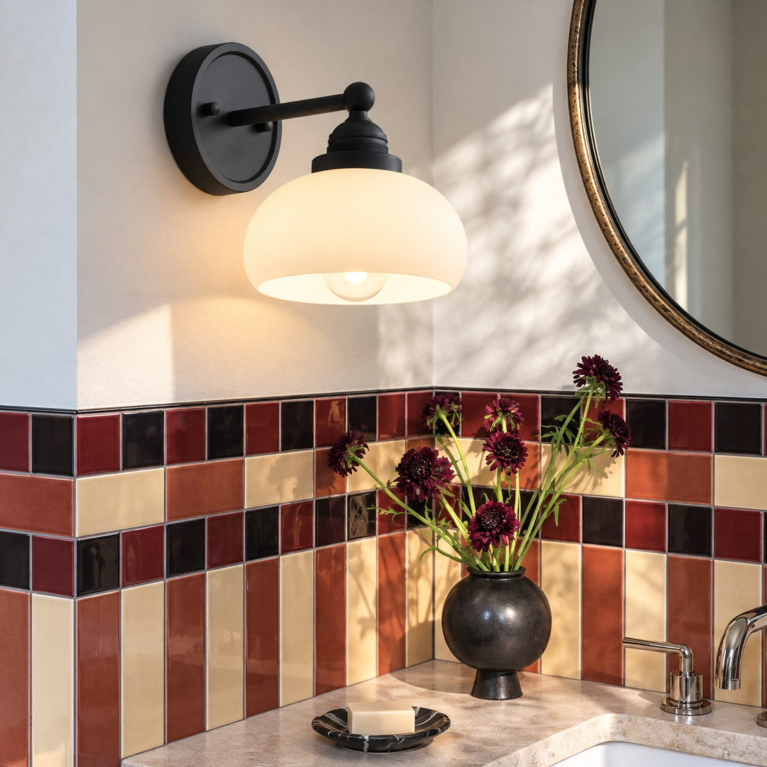 Opelina black milk glass wall sconce styled in a bathroom