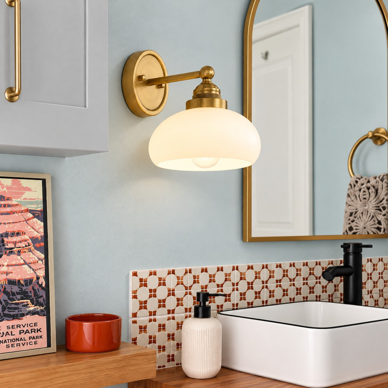 Opelina brass milk glass wall sconce styled in a bathroom