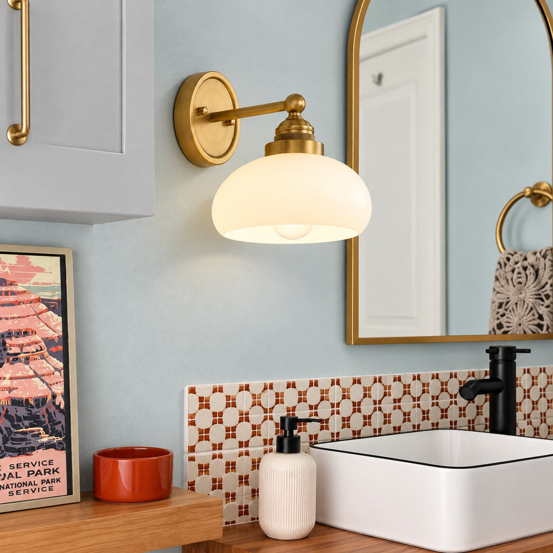 Opelina brass milk glass wall sconce styled in a bathroom