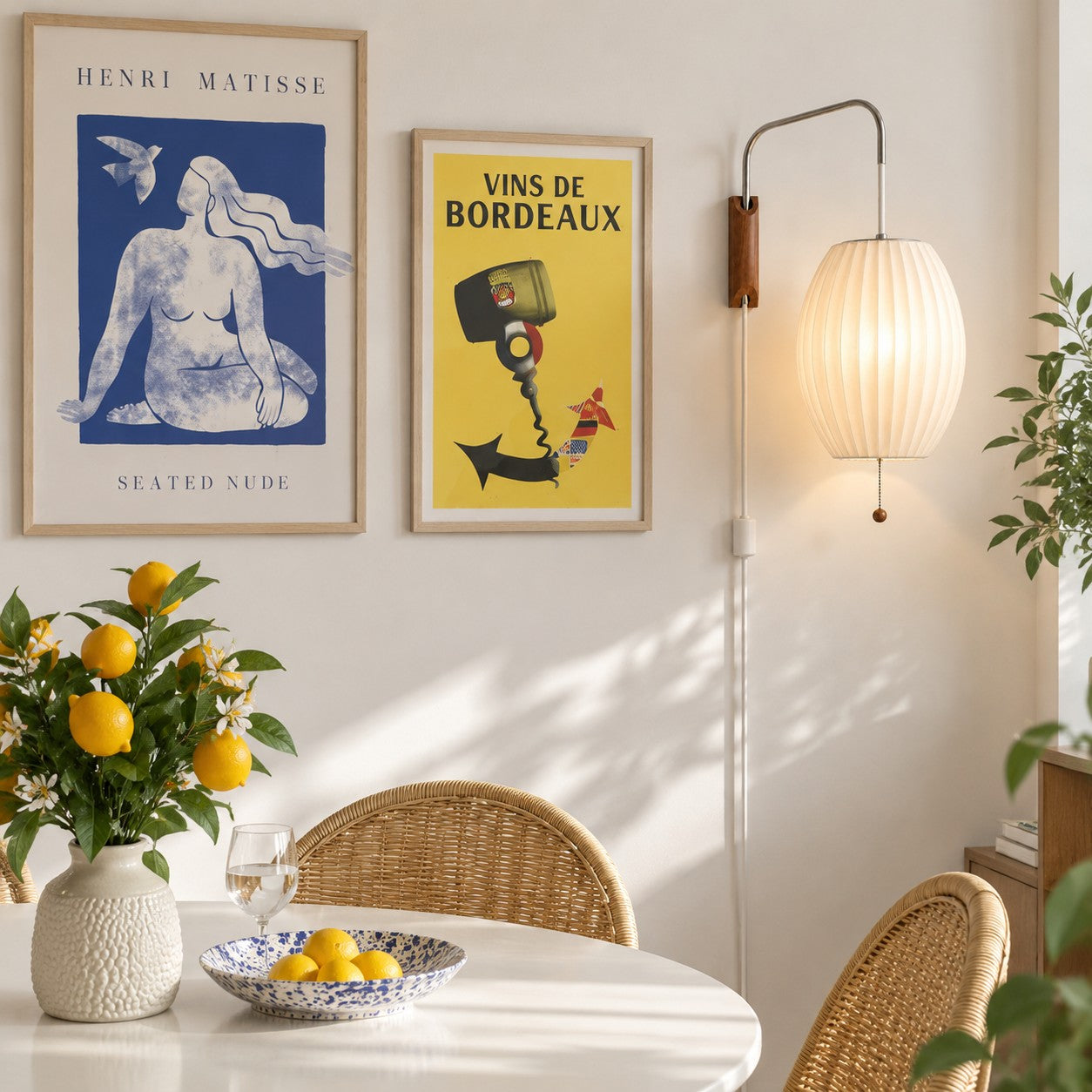 Oriya oval shade plug-in sconce styled with art prints in a dining room