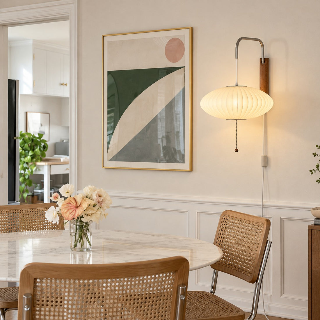 Oriya saucer shade plug-in sconce styled above a dining table