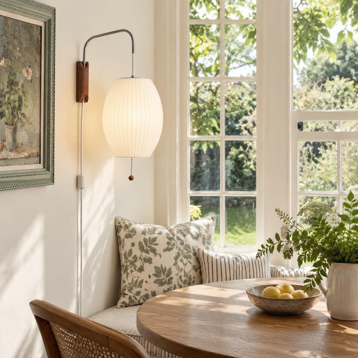 Oriya oval shade plug-in sconce styled in a window breakfast nook