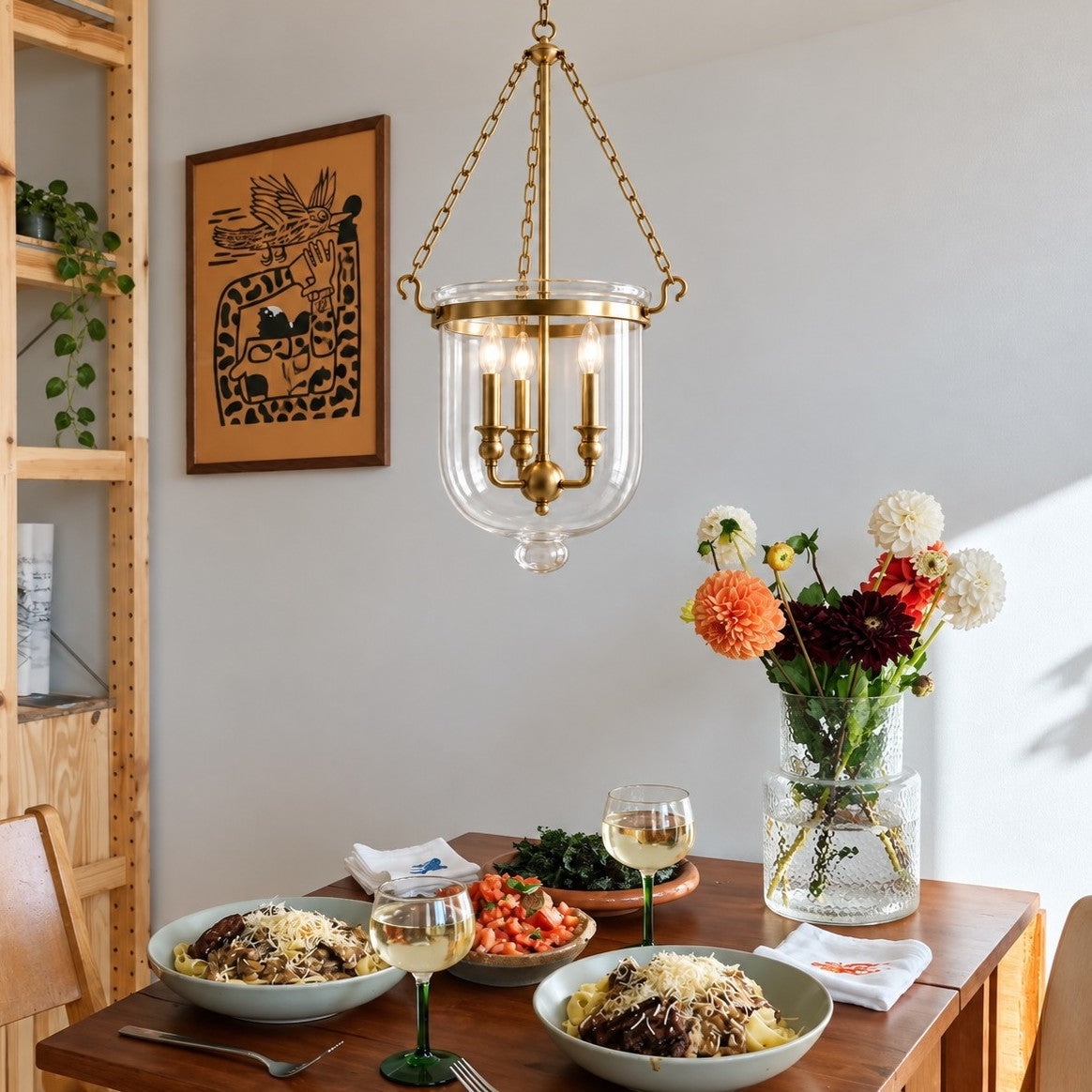 Vitrona clear glass bell jar pendant styled in a kitchen dining space