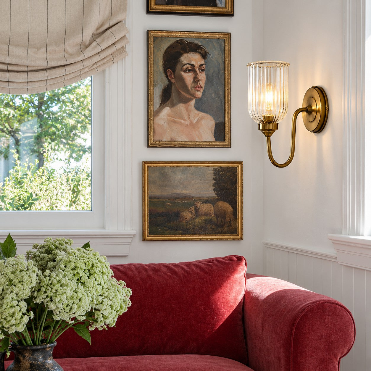 Vitrona ribbed glass wall sconce styled above a red living room sofa